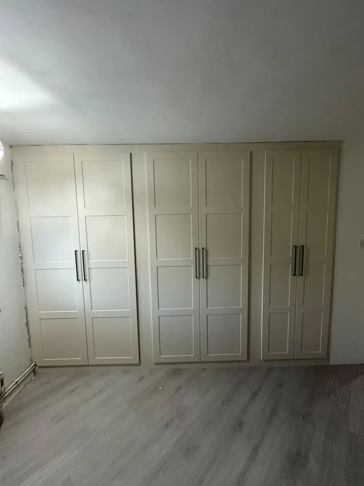 White shaker fitted wardrobes built into a bedroom