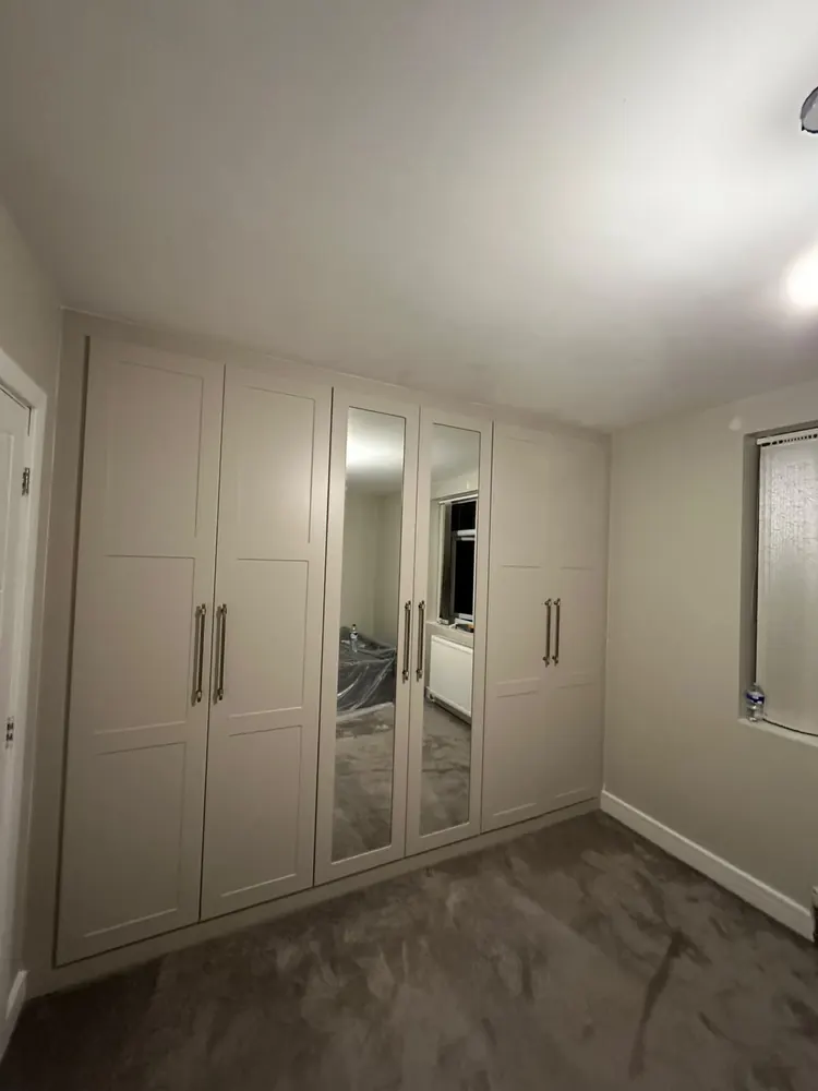 White sliding wardrobe with a central mirror panel