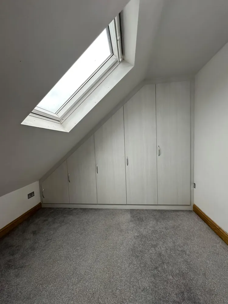 Loft wardrobe fitted neatly into a sloping ceiling