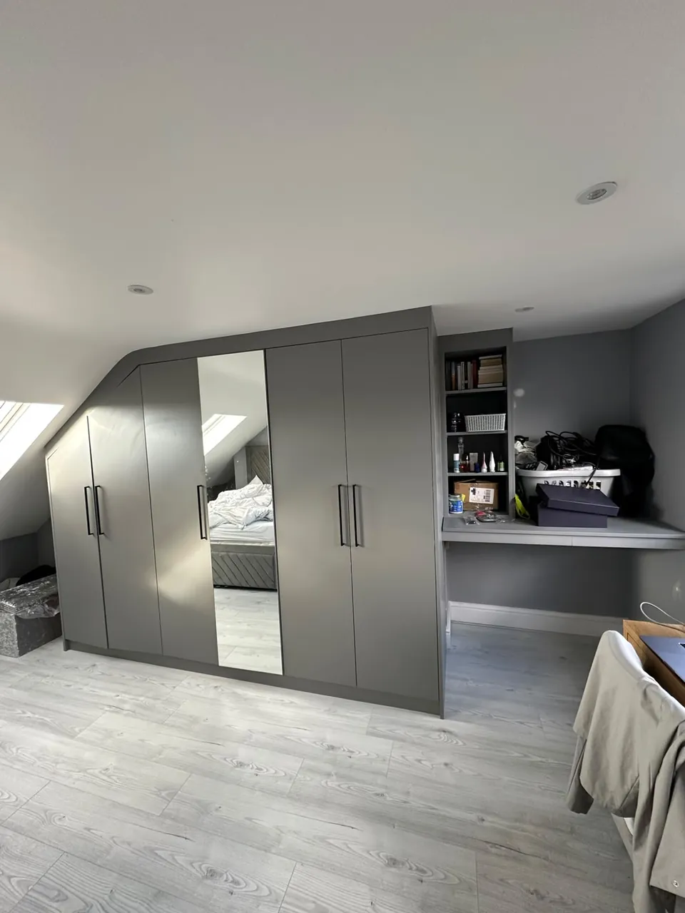 Modern grey gloss fitted wardrobe in a styled bedroom
